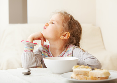 Girl looks with disgust for food